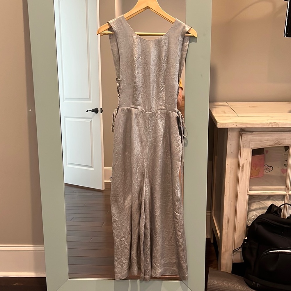 J.O.A. Los Angeles silver jumpsuit. Open back, tie sides, sits above the ankle